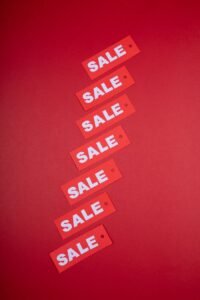 Vertical arrangement of red sale tags on a vivid red background, ideal for retail promotions.